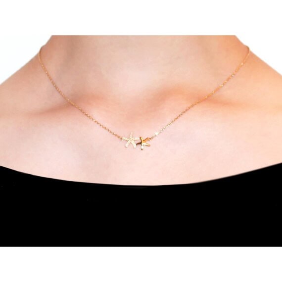 Collier en plaqué or, doté de deux étoiles de mer. Chez Poisson Plume