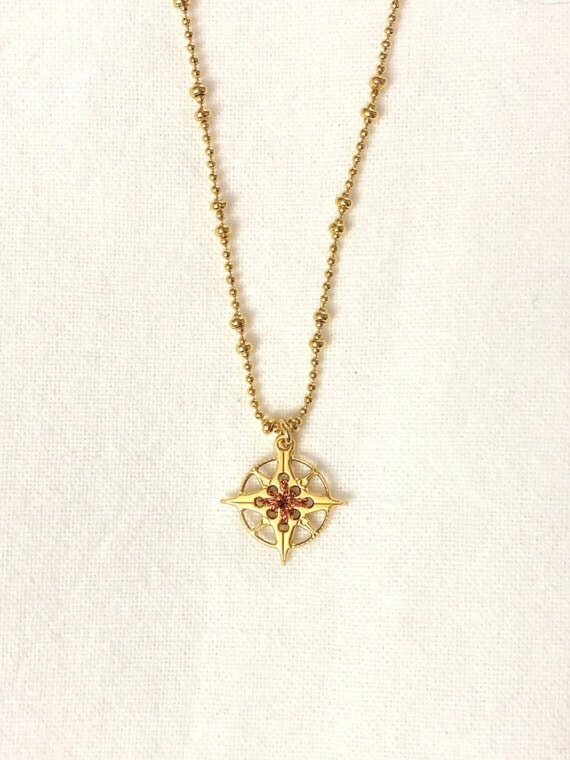 Collier rose des vents boussole cuivrée chez poisson plume